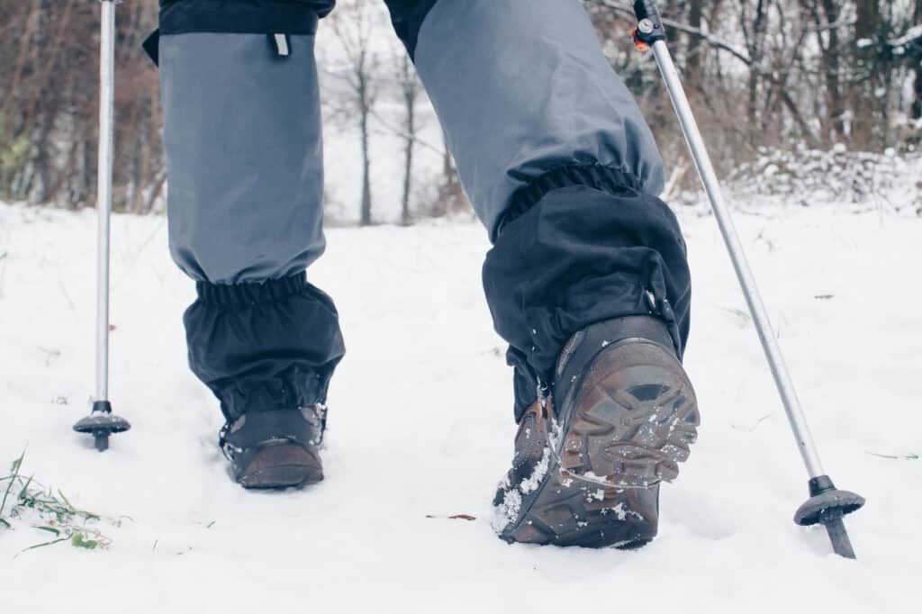 Hiker in snow with boots and gray gaiters