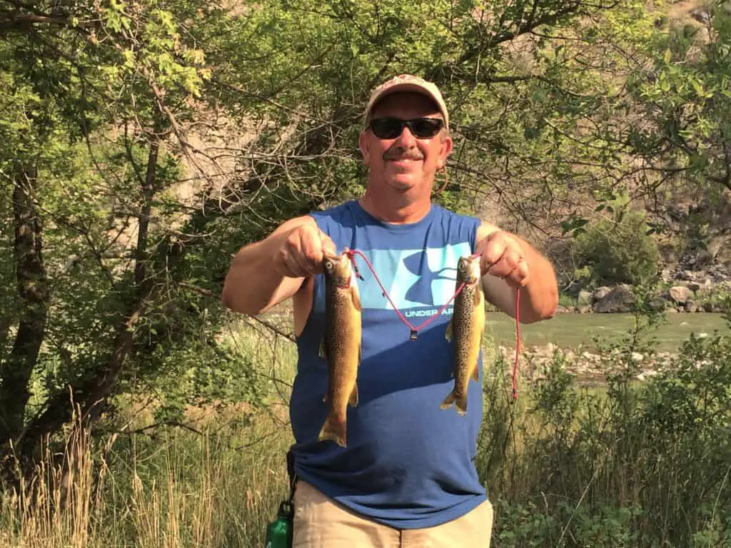 Brad holding 2 trout by Jones Hole Creek