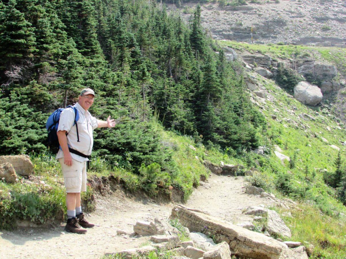 man walking along trail in mountains