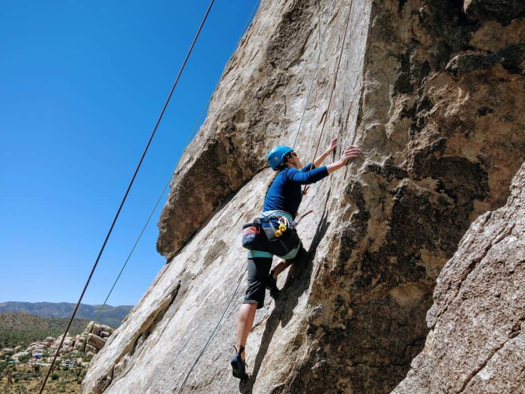 Woman rock climbing in Joshua Tree National Park