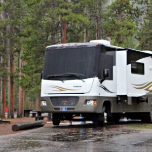LArge white RV parked on blacktop in MAdison Campground in Yellowstone National Park