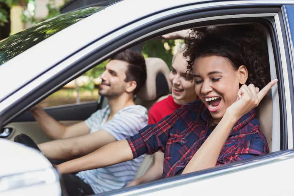 people in car singing along to song on road trip