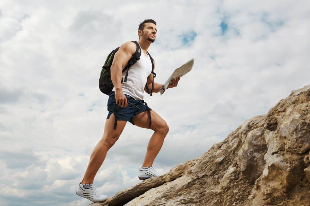 Man hiking mountain, demonstrating the benefit of wearing the best mens hiking underwear