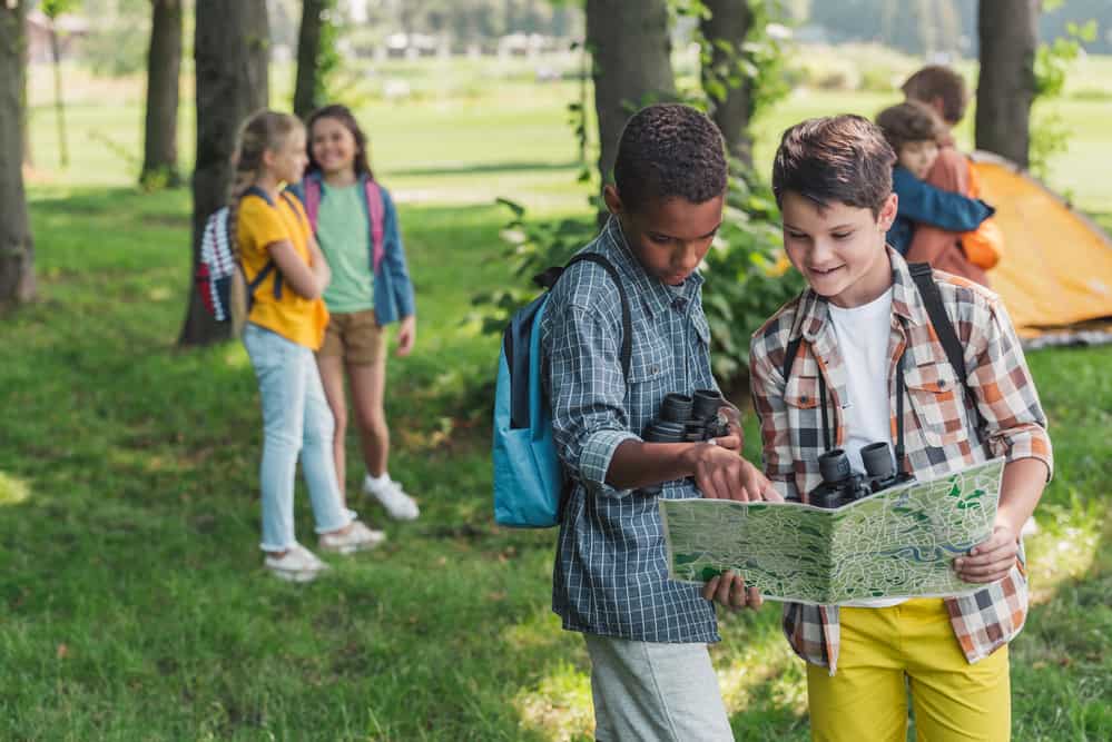 Children preparing to hike by looking at map