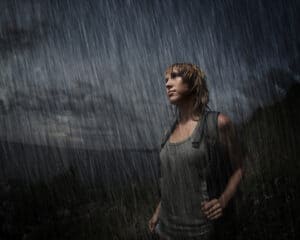 Woman soaking wet while hiking in rain
