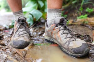 Wet hiking shoes in a puddle after a hike in the rain