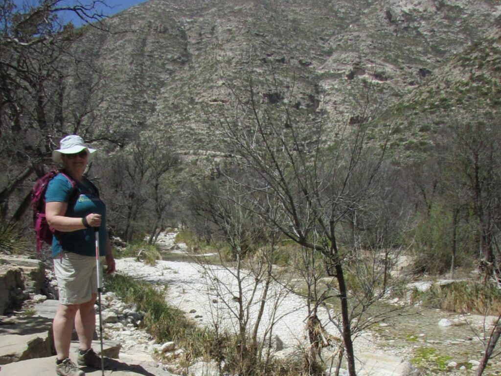 woman standing on hiking trail