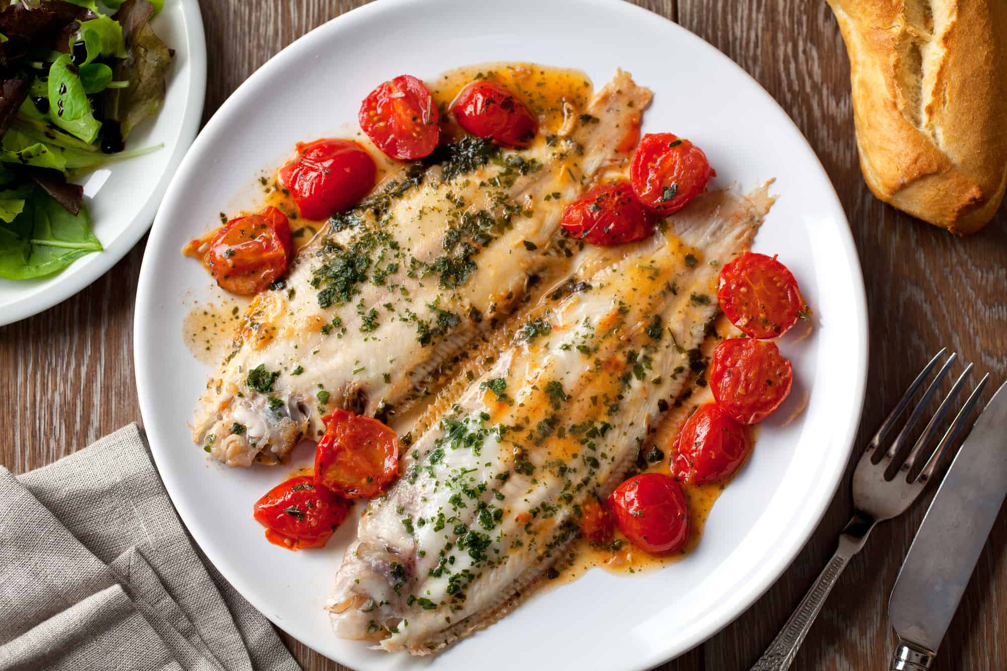 Plate of food with fish and tomatoes