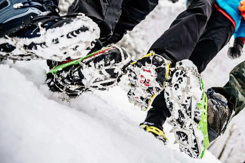 four shoes showing the difference between microspikes vs crampons