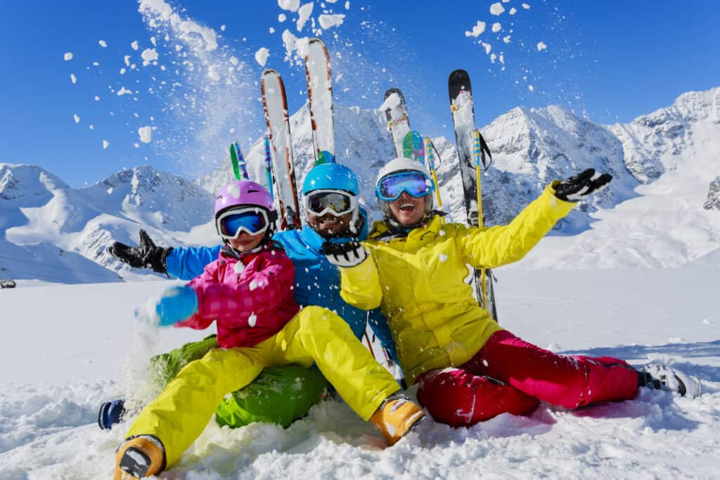 Three Skiiers on snowy mountain in Winter Park near Rocky Mountain National Park