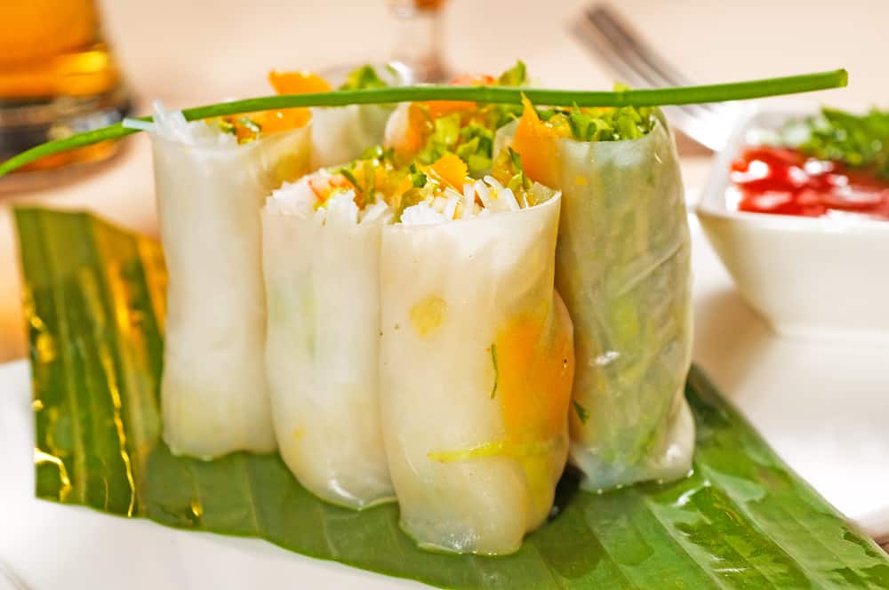 six summer rolls on a sheet of green. ready to take on a day hike for lunch