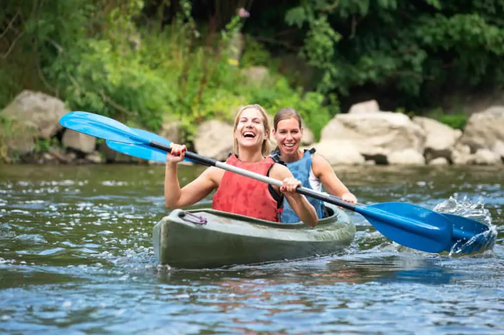 2 women kayaking on a river