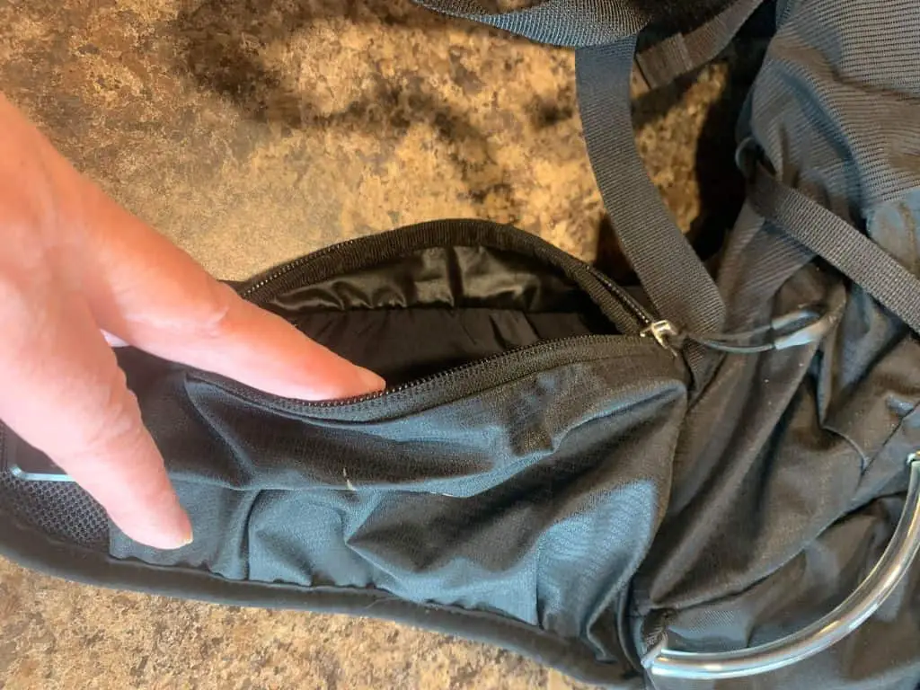 Waist pocket on a black backpack, an important feature in top daypacks for hiking.