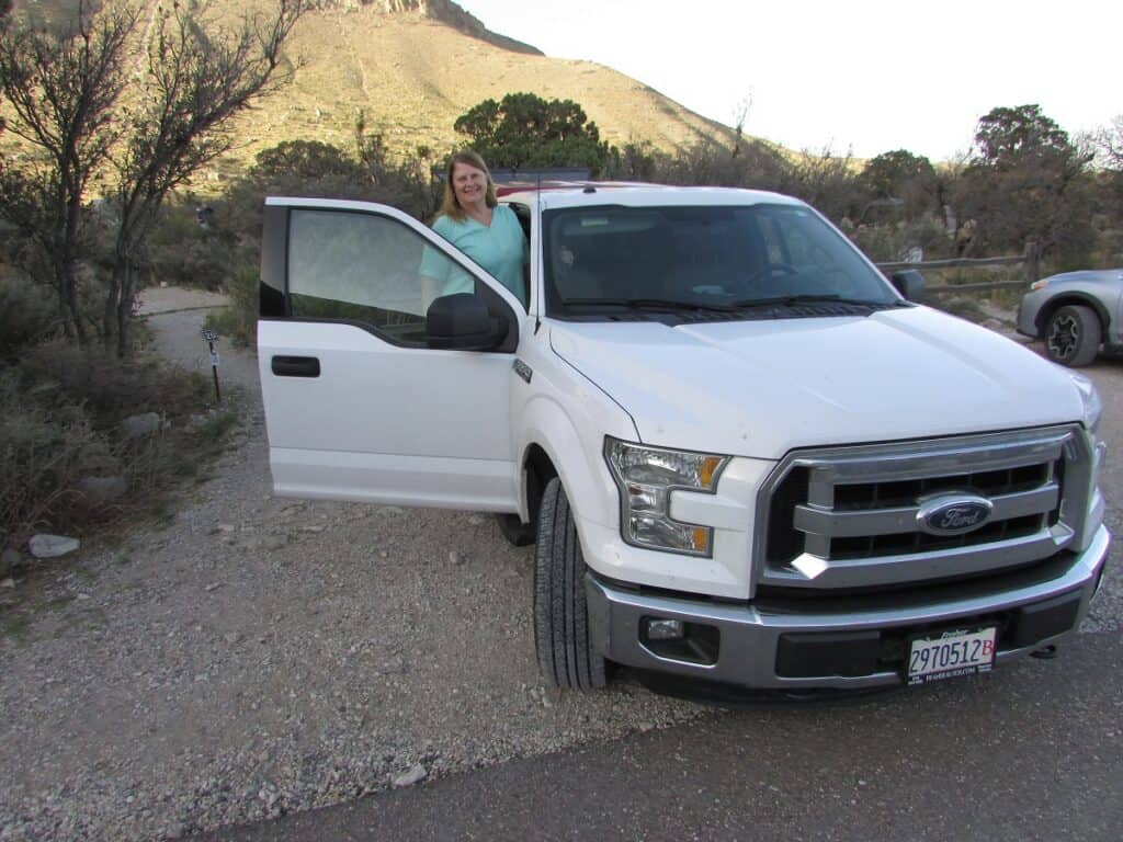 woman in white truck ready for road trip in texas
