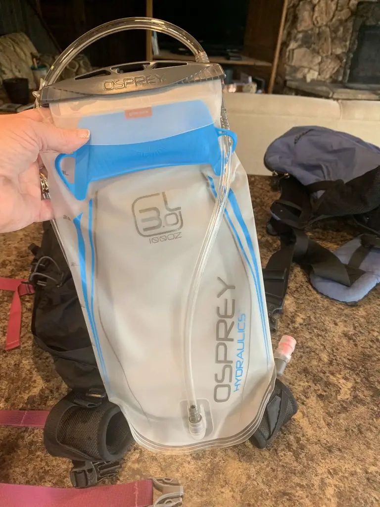 3 liter water bladder being held next to backpack