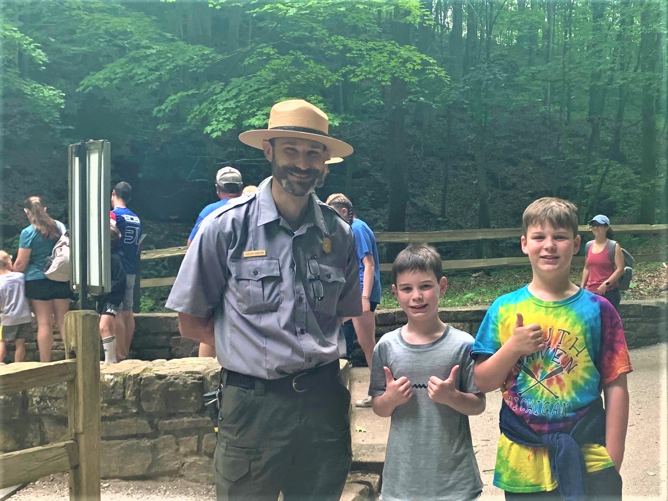 Ranger standing outside Mammoth Cave Historic Tour with our grandsons. Boys have thumbs up