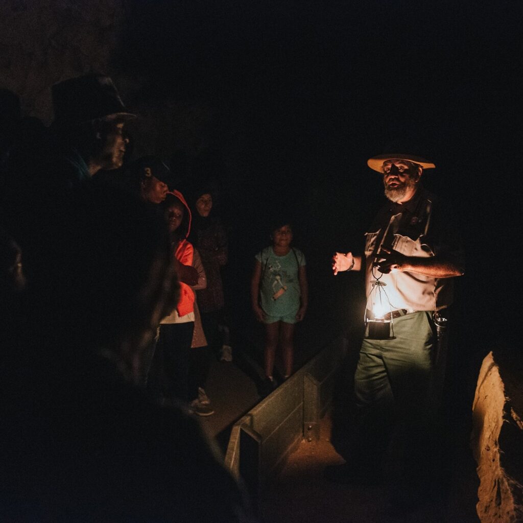 Ranger Guide telling story to children on the Violet City Lantern Tour at Mammoth Cave National Park