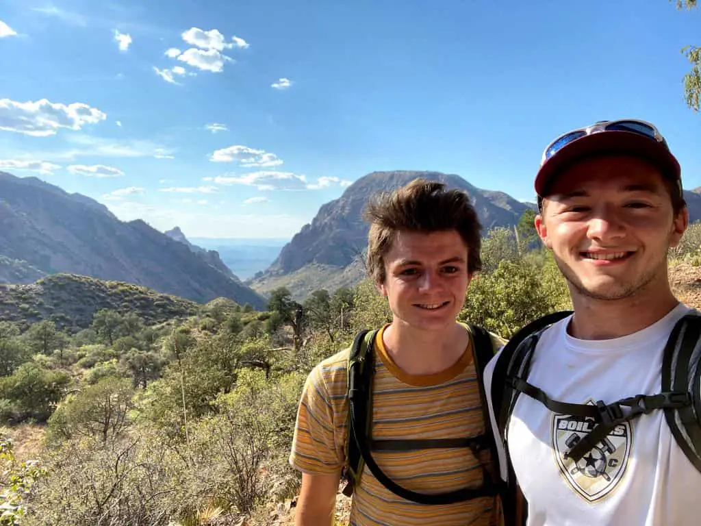 2 hikers with mountains in background on the South Rim Trail in Big Bend