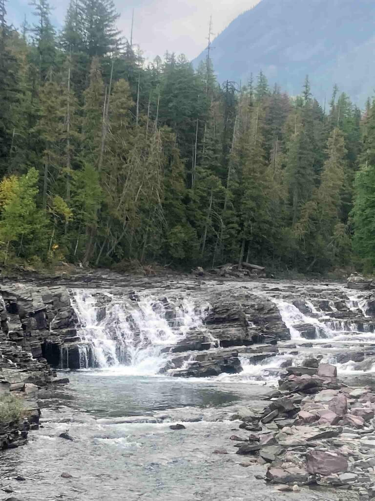 Cascade of water over rocks along Going to the Sun Road