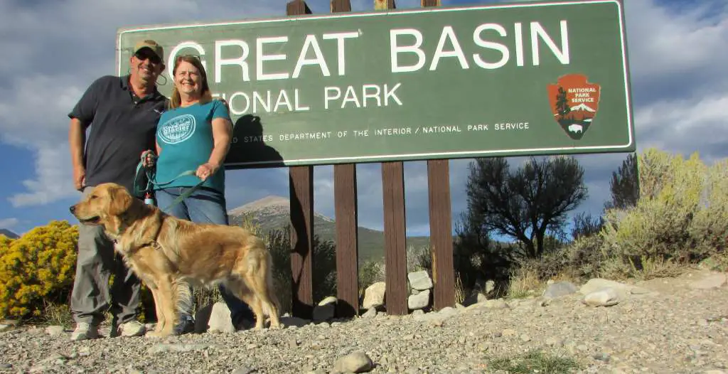 Brad and Ladona and dog standing in front of the Great Basin welcome sign, the first stop on the Great BAsin itinerary.
