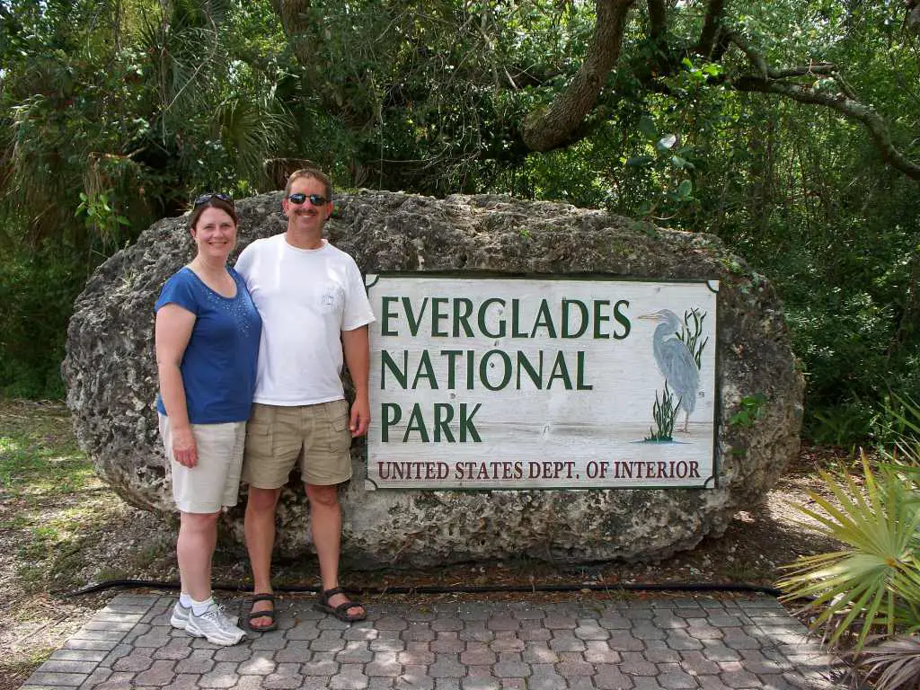 two people standing in front of entrance sign to everglades National Park