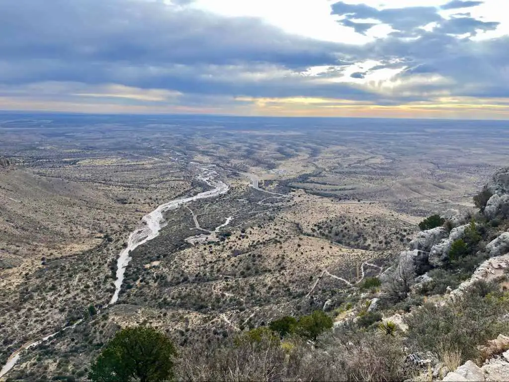 View from trail while hiking Guadalupe Peak with sunrise in distance