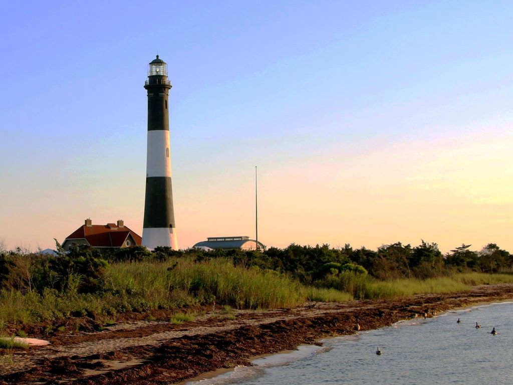 Lighthouse sitting on edge of beach