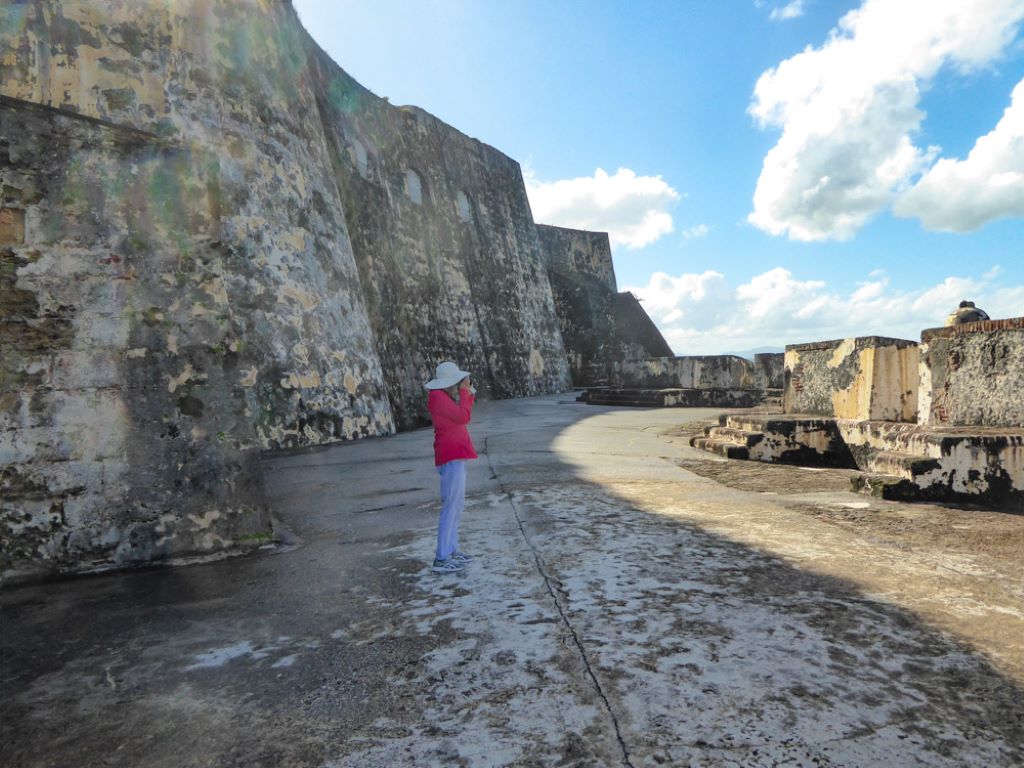 woman taking photo of San Juan Historic Site