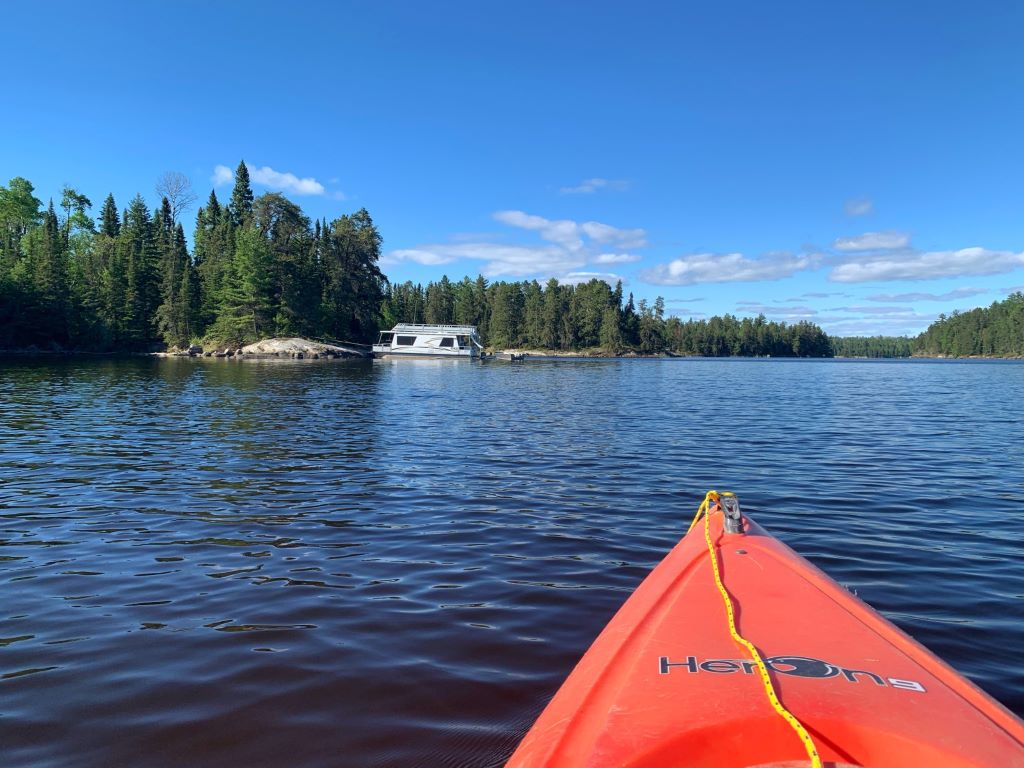 tip of red kayak pointing across lake