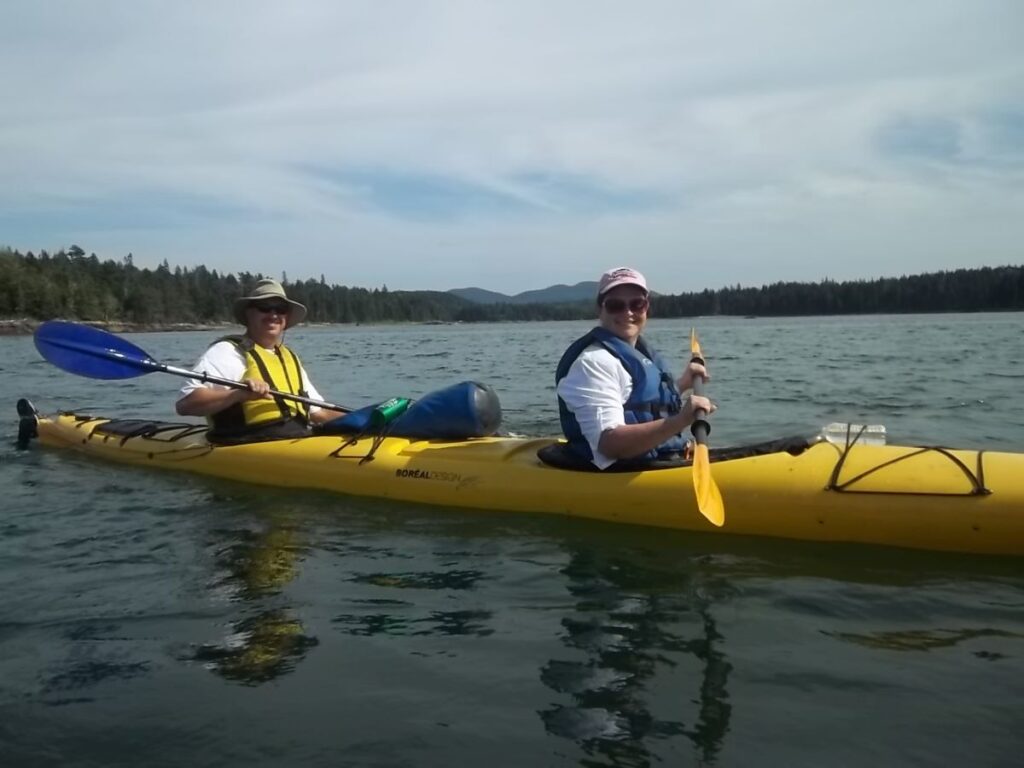 man and woman in yellow kayak in national park