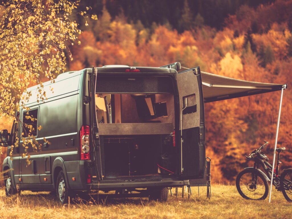 campervan in woods with fall colors