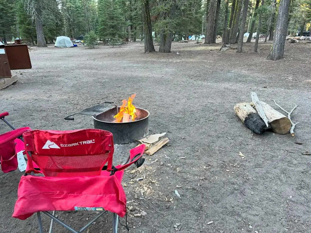 Red chair in front of a campfire in Manzanita Campground in Lassen