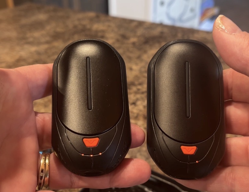 2 black handwarmers held in hands