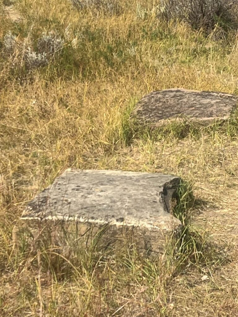 large blocks of stone that were once the footers for a cabin sitting in the prarie