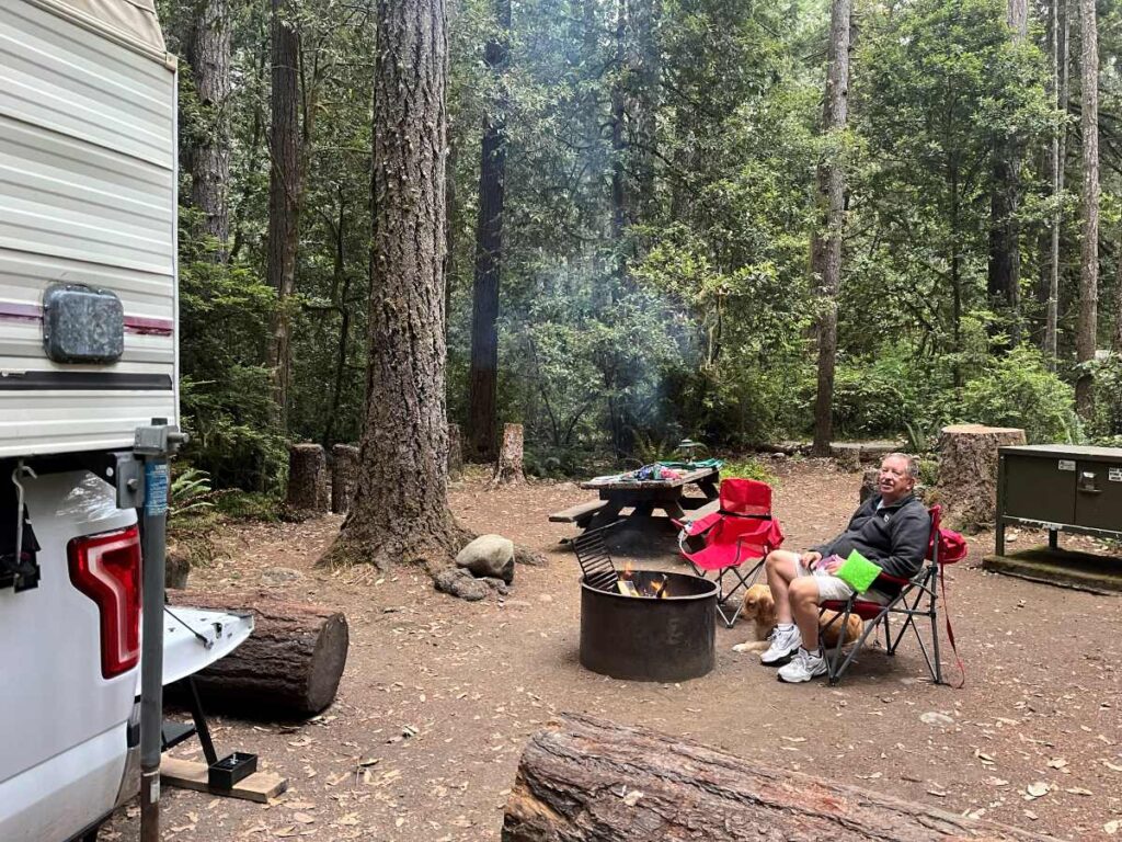 man in front of campfire